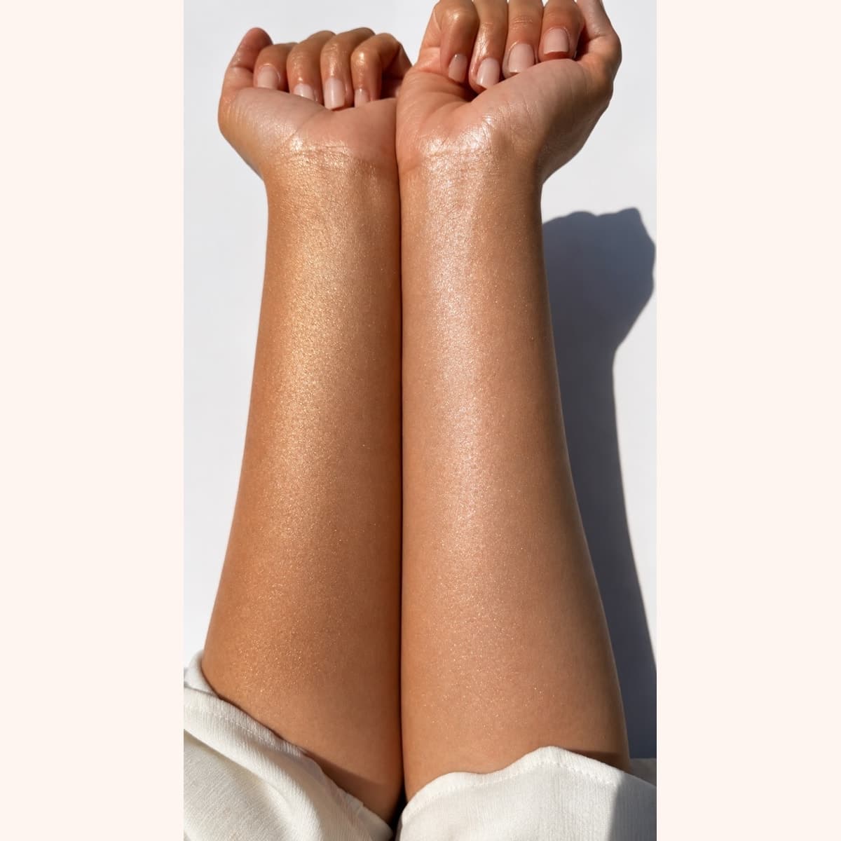 Bronze Glow and Sunkissed Body Shimmer shown on two forearms